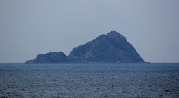 Image of a mountainous island surrounded by water.